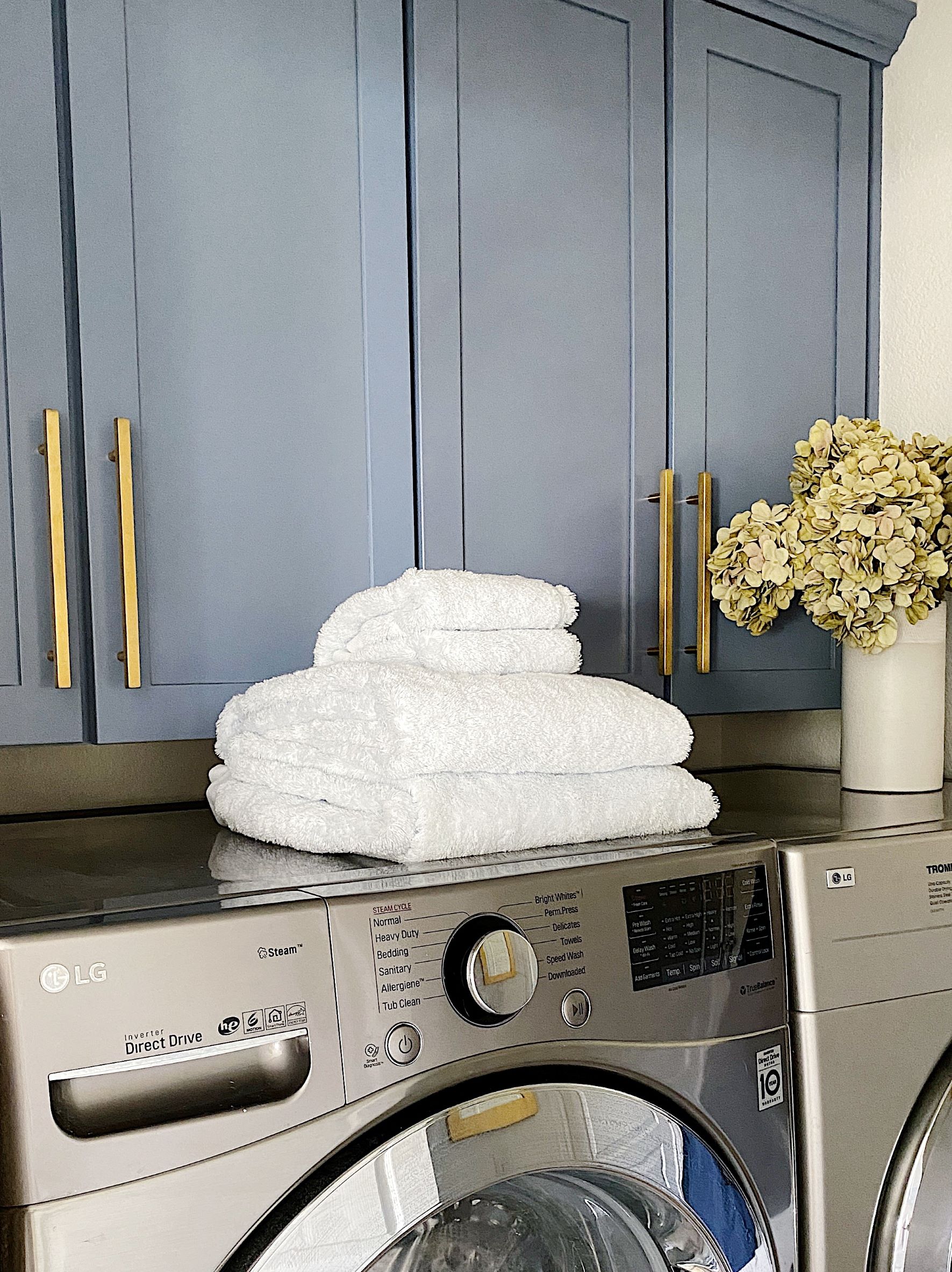 Our laundry room cabinets are painted with Bracing Blue by Sherwin Williams - jane at home