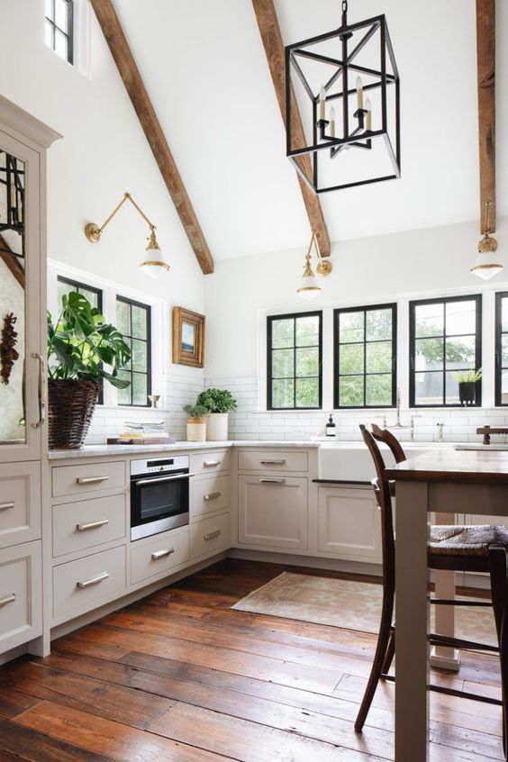Charming English country cottage kitchen with vaulted ceilings, wood beams, and Turkish vintage runner - Jean Stoffer Interior Design