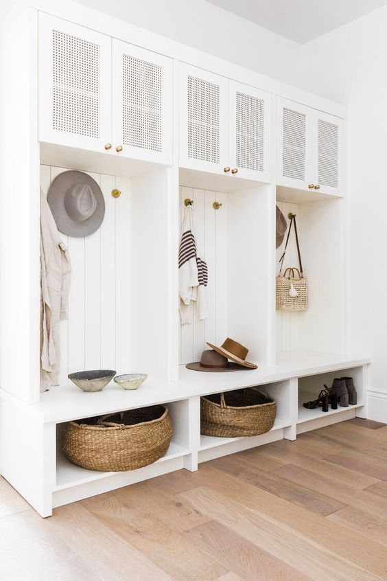 Beautiful white modern mudroom with built in cabinets and shelves and vertical shiplap - thelifestyled co. interior design