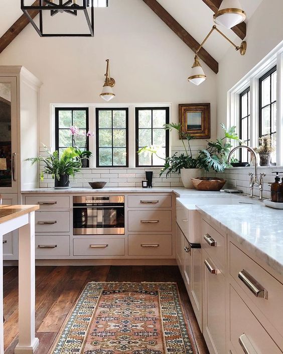 Love this beautiful kitchen with vaulted cathedral ceilings and a vintage rug 