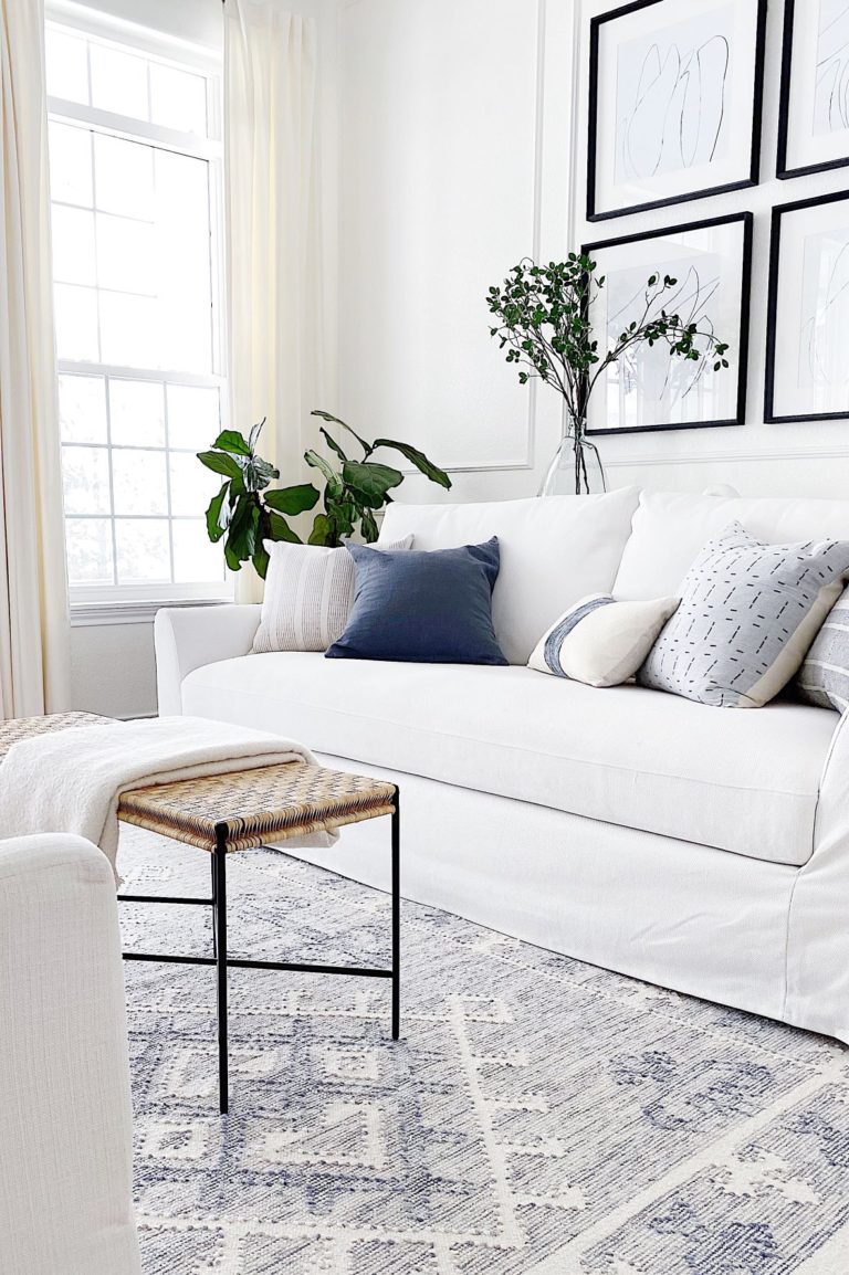 Modern living room with white slipcovered sofa and neutral pillows, rug, furniture and decor - jane at home - ikea farlov review