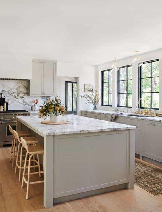 Love this beautiful kitchen design with grey cabinets, marble countertops and black framed windows - european style kitchen - gray kitchen cabinets - kitchen cabinet ideas - modern kitchen - amber interiors kitchen