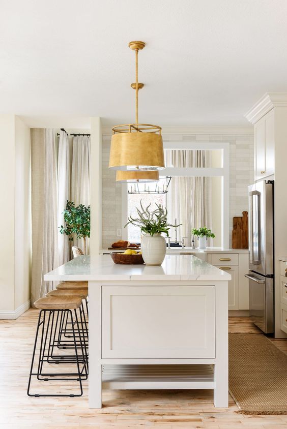 Beautiful modern kitchen design with light gray beige island color and brass pendant lights - studio mcgee netflix kitchen remodel 