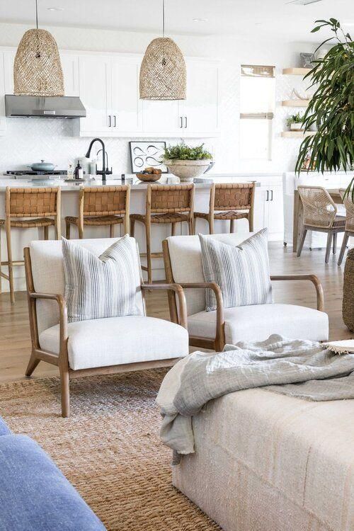 Love this beautiful modern living room and open concept space with two mid-century modern chairs, a jute rug, and neutral furniture and decor - living room ideas - living room furniture - living room decor - modern coastal decor - coastal living room - pure salt interiors