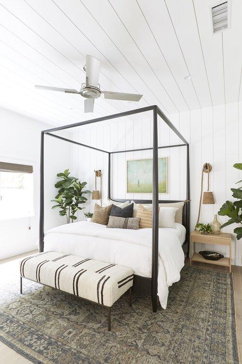 Love this beautiful modern coastal bedroom design with a black canopy bed - pure salt interiors