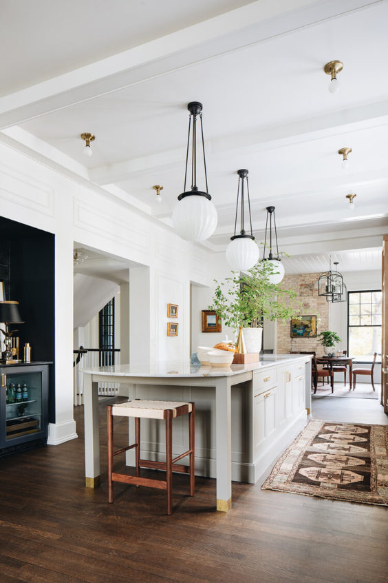 Beautiful kitchen design with gray cabinets and striking pendant lights over the island