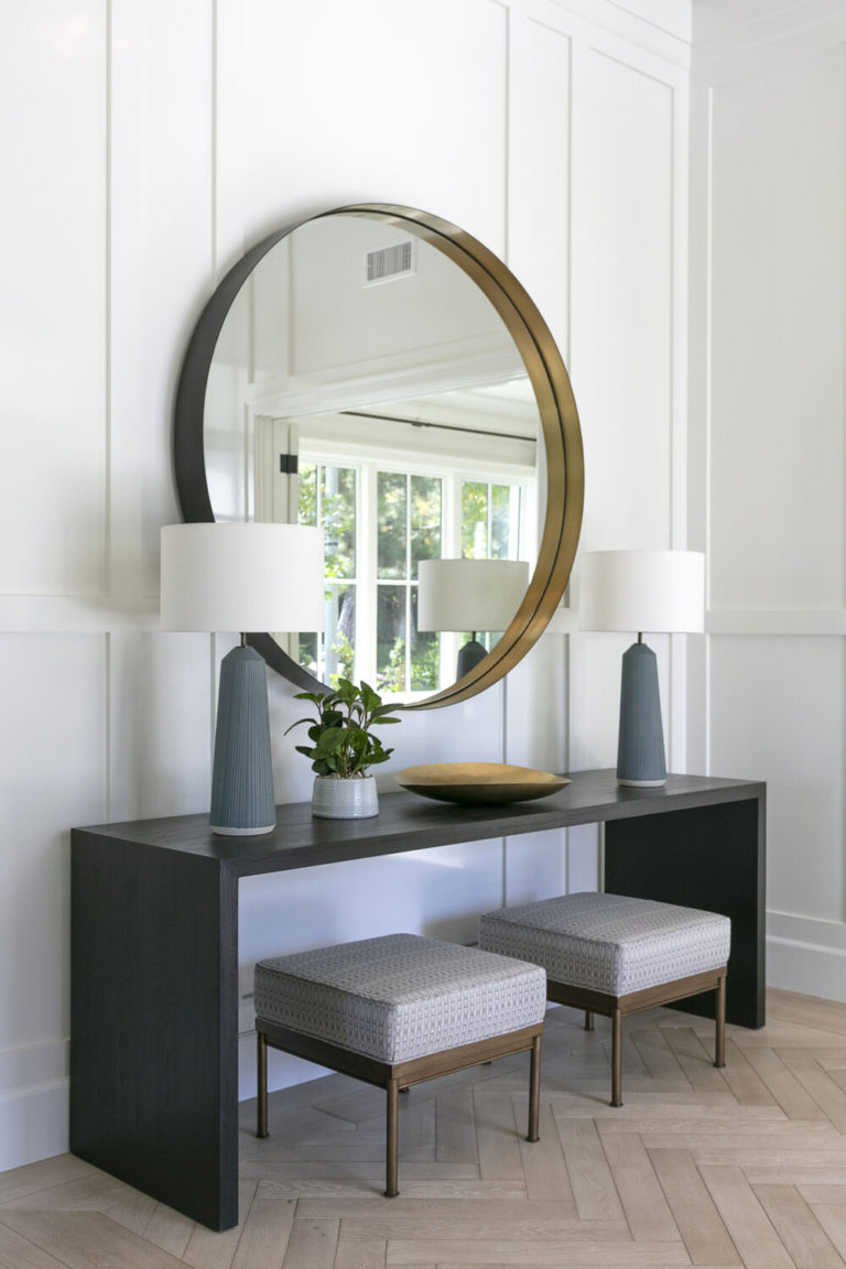 Love this beautiful modern entryway with a large round mirror and black console table - brooke wagner design