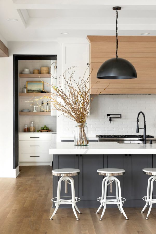 Love this beautiful kitchen design with a wood range hood, dark island cabinet color, and black dome pendant lights - kitchen remodel - modern kitchen ideas