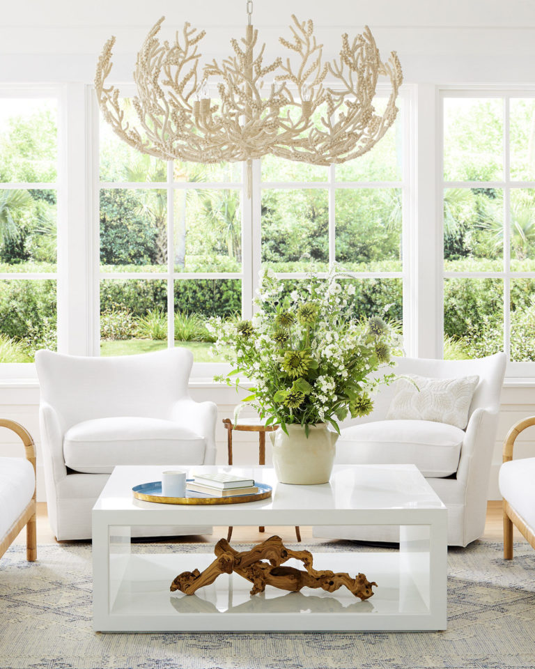 Love this beautiful living room with a white coffee table and swivel chairs