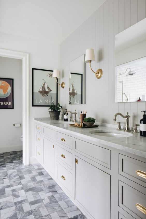 Love this beautiful bathroom design with a mix of brass and polished nickel fixtures, as well as a gray vanity with double sinks - jean stoffer
