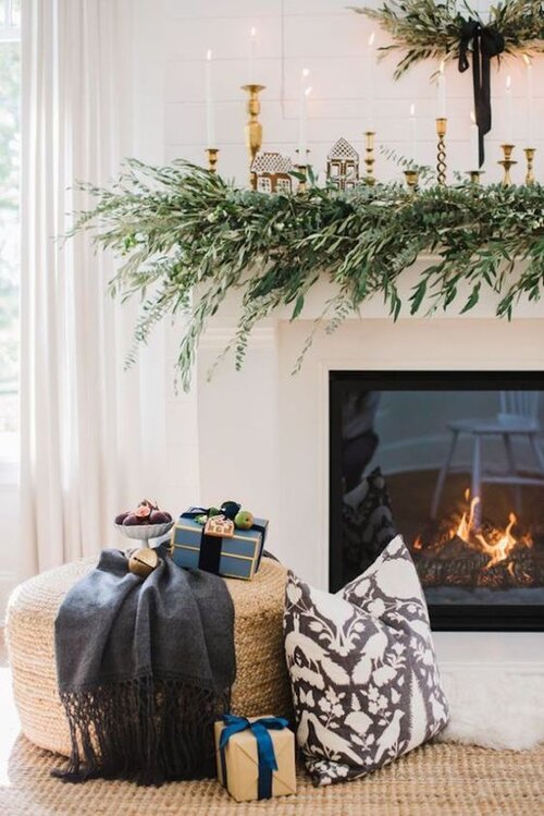 Love this beautiful Christmas fireplace decor with evergreens and tiny houses decorating the mantel - Monika Hibbs - Christmas decor - Christmas mantel - mantel decor - mantel ideas - mantle decor - Christmas mantle - holiday decor