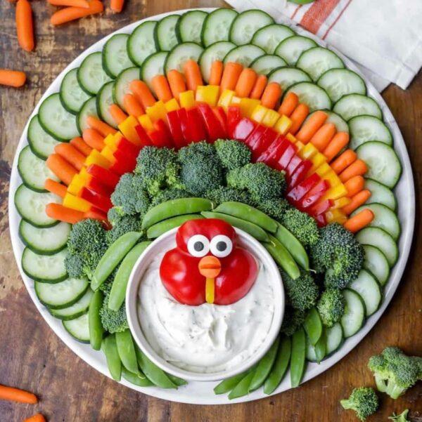 Love this amazing Thanksgiving vegetable tray, featuring a red pepper turkey face, dip body, and veggie feathers - lil luna - thanksgiving table ideas - thanksgiving appetizer - thanksgiving recipe