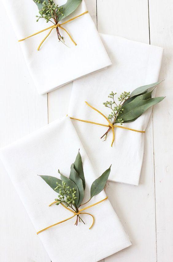 Love this beautiful place setting idea for a Thanksgiving or Christmas tablescape, with white napkins and eucalyptus sprigs - Thanksgiving table ideas - table decor - holiday table - Thanksgiving decor - Christmas decor - Christmas table