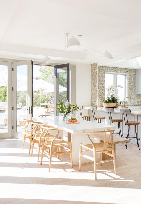 Love this beautiful modern dining room and open concept kitchen design with a long dining table and light wood wishbone dining chairs - dining room ideas -dining room furniture - modern coastal dining room - alexander design