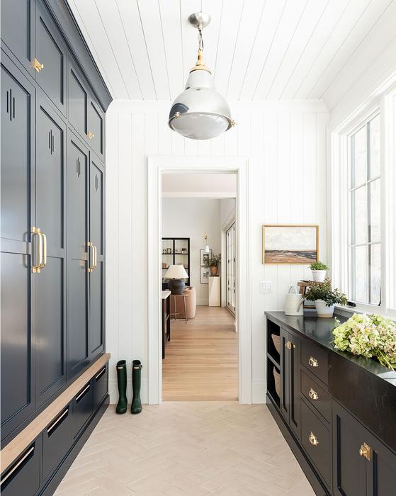 Love this beautiful pass-through mudroom design with dark blue-black cabinets, an industrial pendant, and European farmhouse style - kitchen ideas - mud room - mudroom - utility room ideas - entryway ideas