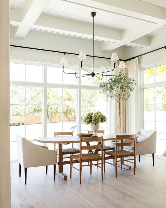 Love this beautiful transitional dining room with an oval wood dining table, dining chairs and modern chandelier - dining room decor - transitional interior design - transitional dining room - studio mcgee