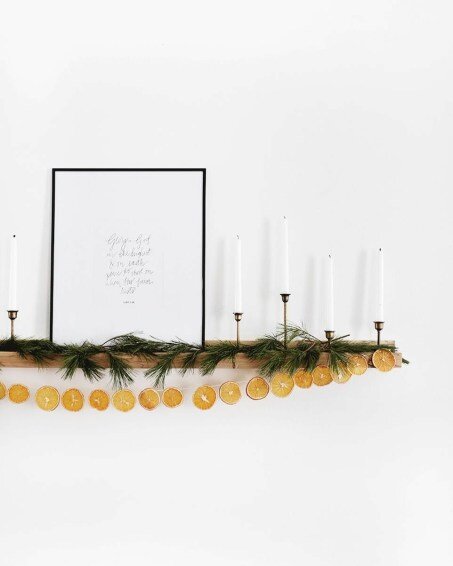 A beautiful modern Christmas mantel with Scandinavian style wood garland, fresh boughs, and rustic decor - the merry thought - Christmas decor - holiday decor - mantel decor - mantle decor