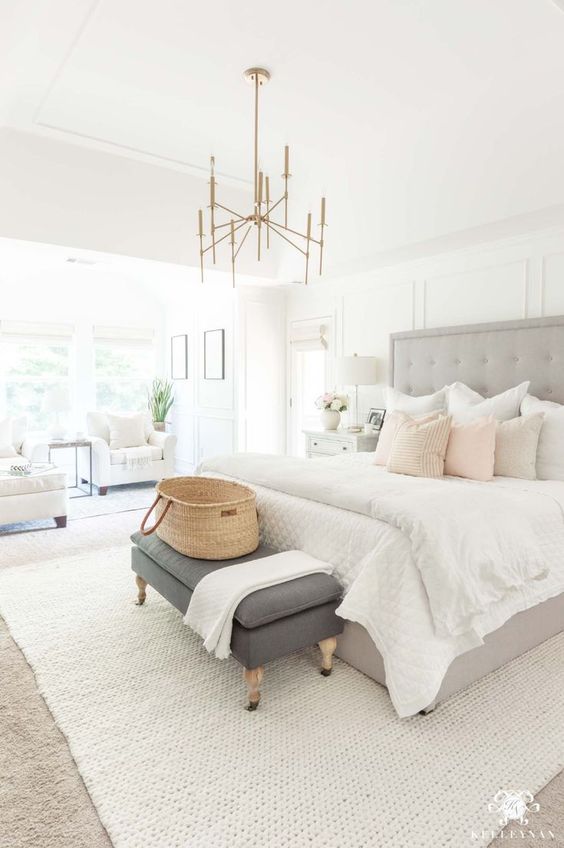 Love this dreamy master bedroom suite with a sitting area, hints of blush, and light neutral decor and furniture - bedroom decorating ideas - luxury bedroom - kelley nan