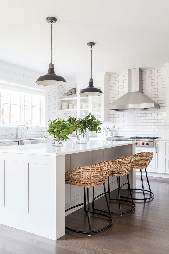 Love this beautiful kitchen design with white cabinets, a subway tile backsplash, woven counter stools and black pendant lights - kitchen ideas - kitchen decor - modern farmhouse kitchen - white kitchen design