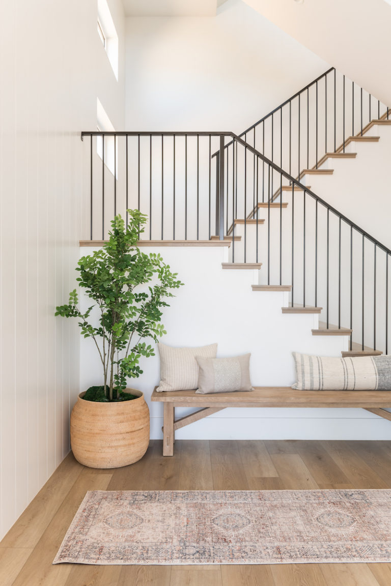 Love this beautiful modern entryway with a bench, pillows, plant, and staircase - becki owens