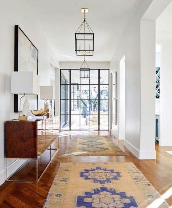Love this beautiful entryway design with a glass front door and abundant natural light - jenkins interiors