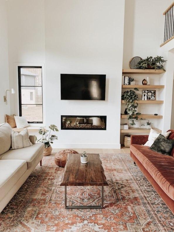 Beautiful modern living room design with fireplace and rust velvet sofa - kassandra dekoning