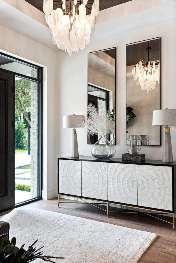 Love this elegant and timeless entryway design with a statement chandelier and beautiful console cabinet - m lahr homes