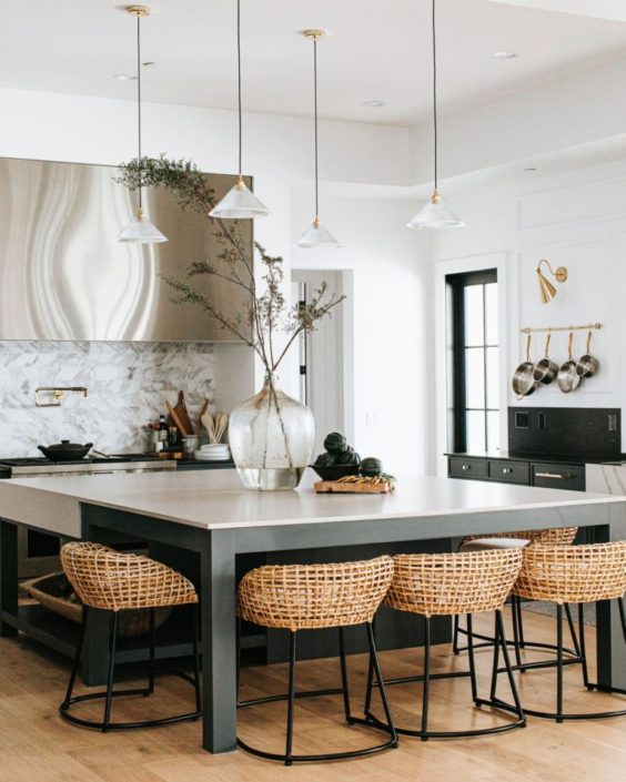 Love this beautiful kitchen with a dark island color and woven counter stools