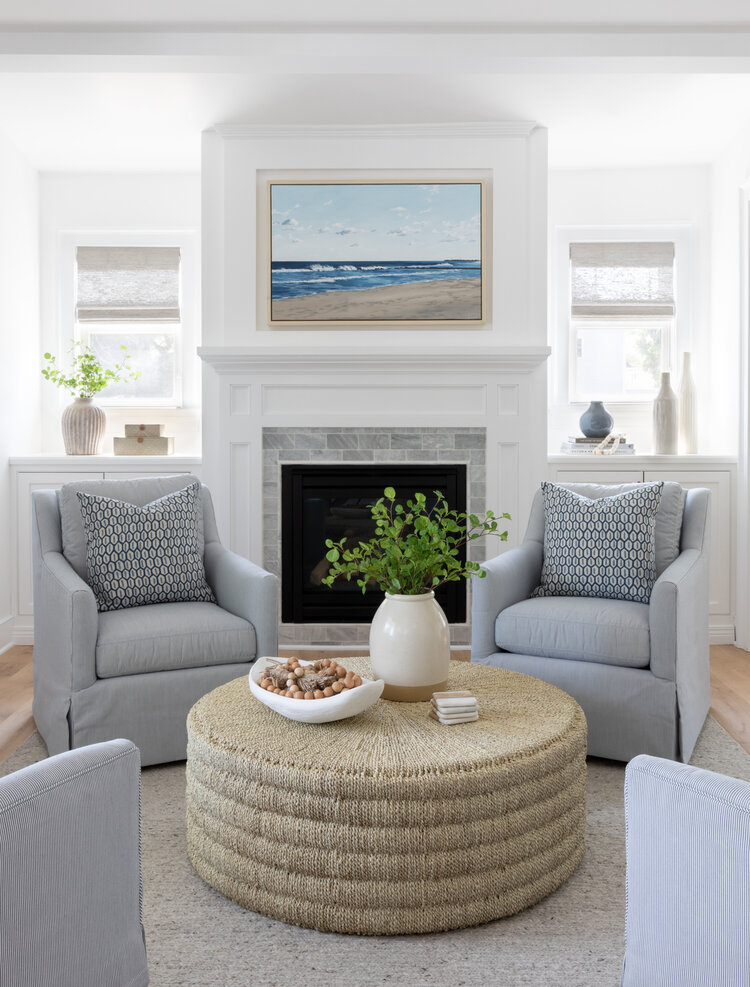 Love this beautiful modern coastal living room and conversation area with a round woven ottoman and four light gray swivel chairs - small living room - living room furniture - neutral decor - coastal interiors - coastal style - salt design 