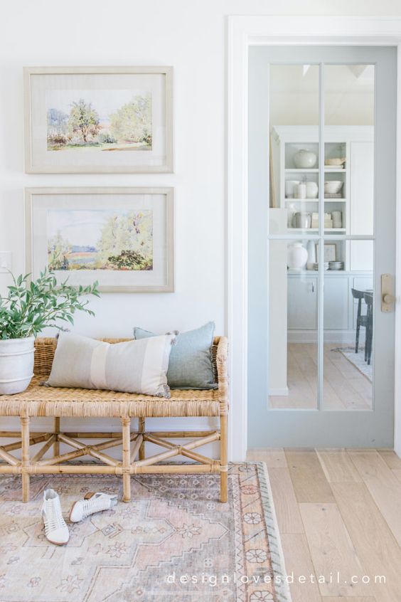 I love this beautiful modern entryway with a woven bench and neutral coastal inspired artwork and pillows - design loves detail - foyer - entryway ideas - entryway decor 