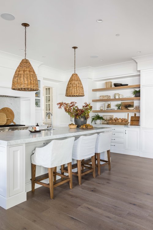 A stylish modern kitchen design with slipcovered counter stools and woven pendant lights over the island.  From Pure Salt Interior Design: