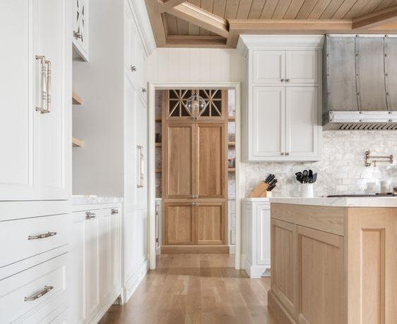 Love this beautiful white kitchen design with herringbone wood floors - a guide to standard kitchen cabinet dimensions, including base, upper, corner, and tall pantry cabinets