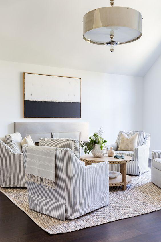 A beautiful living room and sitting area with four swivel chairs around a round coffee table - eye for pretty - amy bartlam photography