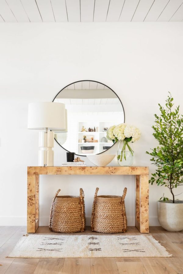 Love this beautiful modern entryway with a burl wood console, round mirror, rug, baskets and neutral decor - entryway ideas - foyer - entryway furniture - entryway decor