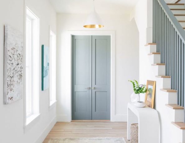 Love this beautiful entryway with a vintage Turkish runner, blue doors and modern white and brass cone pendant light - entryway ideas - entryway rug - entryway decor - entryway lighting