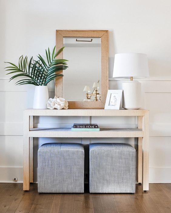 Love this beautiful modern coastal entryway with a console table, two square ottomans, and a woven mirror - courtegli - entry ideas - entryway decor - foyer - coastal interiors