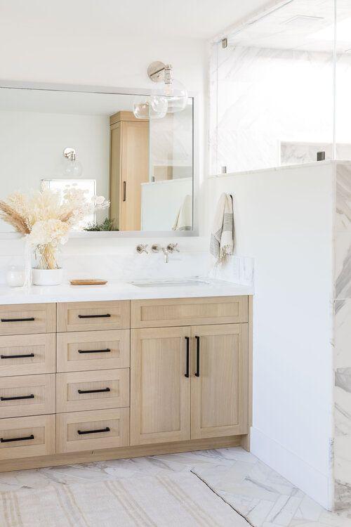 Beautiful bathroom inspiration - light wood vanity with black pulls and chrome faucets and sconces