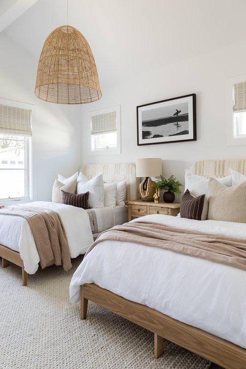 Love this beautiful bedroom idea with two beds, a woven light fixture, and neutral decor and furniture - guest bedroom ideas - guest bedroom decor - guest room - coastal bedrooms - master bedroom - spare bedroom - kids bedroom