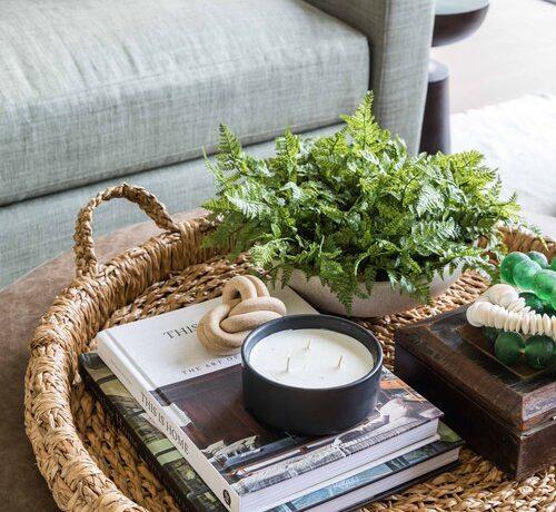 Love this beautiful woven basket tray, decorated with accent pieces and decor on the center coffee table - pure salt interiors