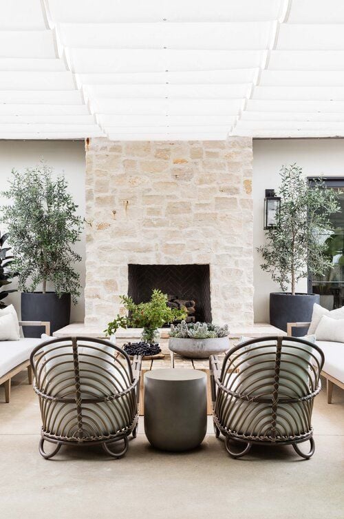 Love this beautiful modern patio with a stone outdoor fireplace - patio furniture - patio decor - patio ideas - porch ideas - covered patio - pure salt interiors