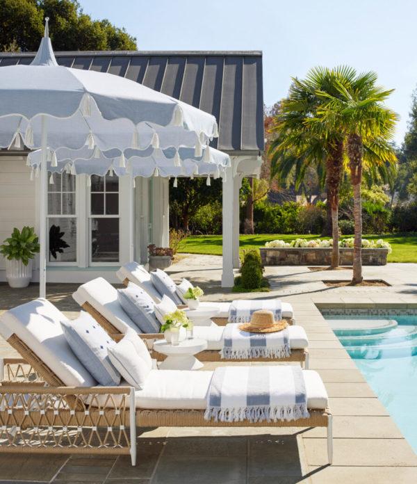 Love this beautiful outdoor living area with modern coastal patio furniture, umbrellas, and decor 