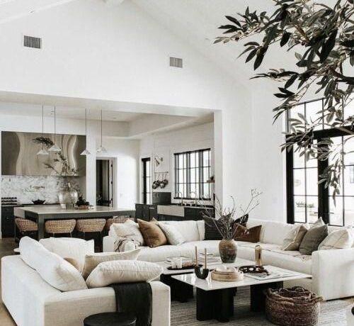 Love this beautiful modern living room design with a large sectional, marble coffee tables, and neutral decor and furniture - living room decor - living room furniture - organic modern decor - warm neutral living room - modern earthy living room ideas - the life styled co