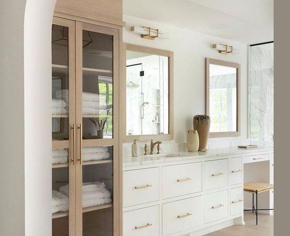 Love this beautiful modern bathroom design with a wood linen cabinet and white double vanity - bathroom remodel - coastal bathroom - west bay homes