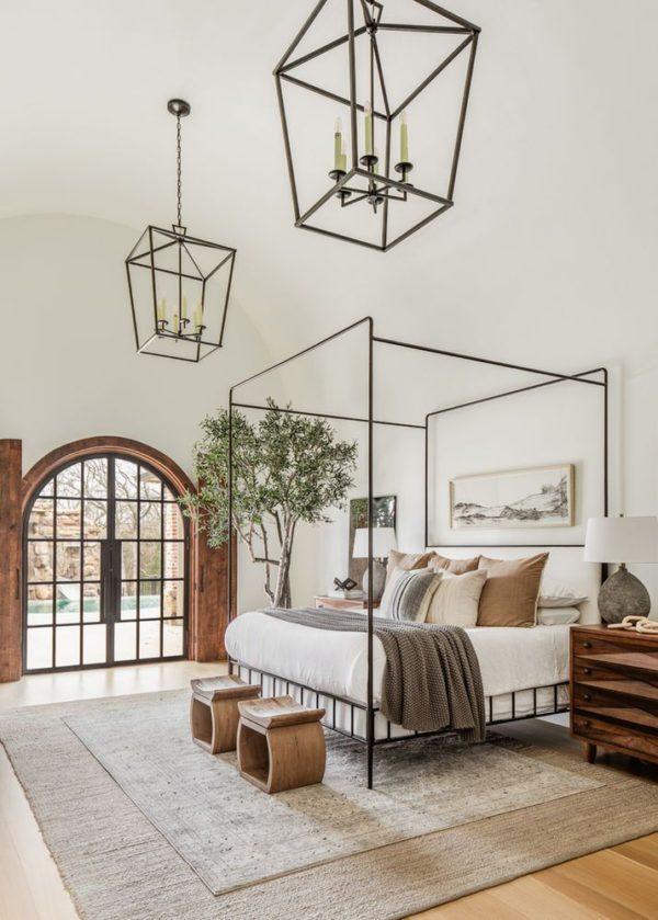 Love this beautiful modern bedroom design with a black canopy bed and neutral bedding, rugs, furniture, and decor - modern farmhouse bedroom - bedroom decor - kelsey leigh design co.