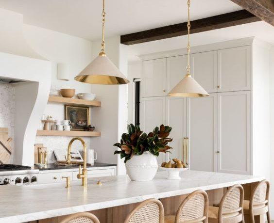 Love this beautiful organic modern kitchen design with curved barstools and pendant lighting over the island