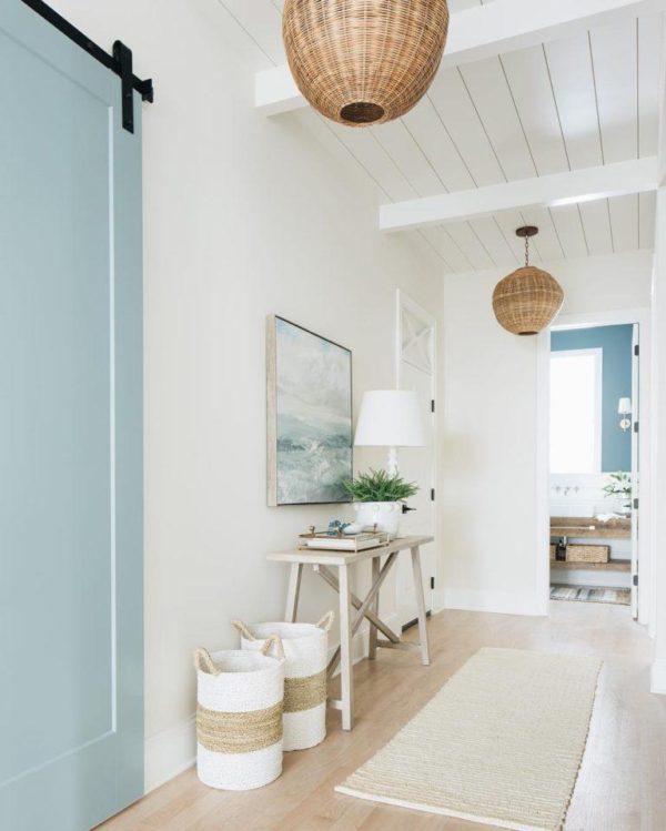 A beautiful modern coastal home hallway and entryway with woven pendant lights and blue sliding barn door - coastal decor - coastal interiors - timber trails