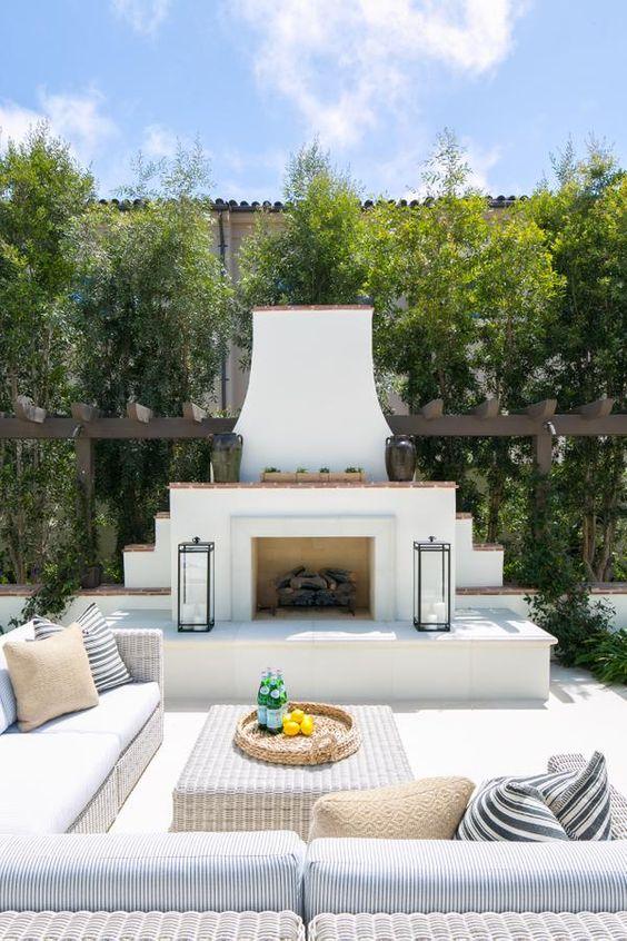 Love this beautiful backyard oasis and patio design idea with seating and an outdoor fireplace - design works - ryan garvin