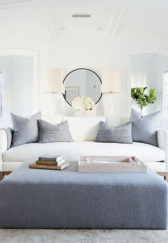 Love this chic modern living room design with a white sofa, blue ottoman, and soft modern coastal style - living room ideas - living room decor - erin fetherston