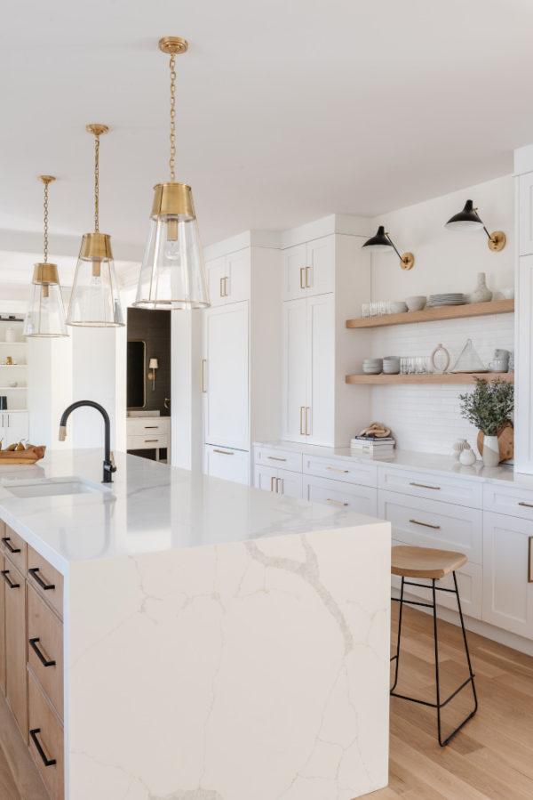 Love this beautiful kitchen design with a waterfall island countertop, white cabinets, a light oak wood island, and brass and glass pendant lights - mif design - ktichen ideas - kitchen lighting - kitchen island 