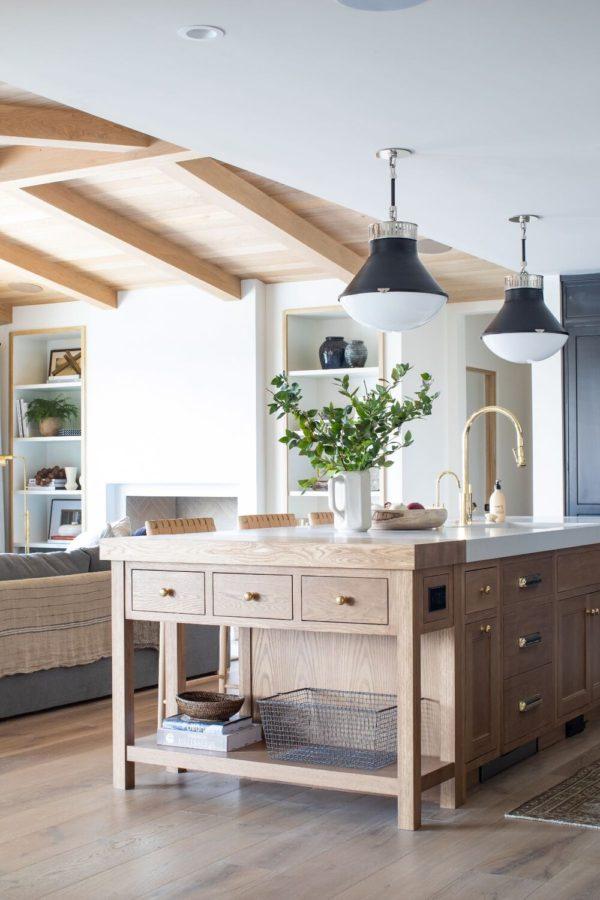 Love this beautiful kitchen design with a warm wood kitchen island, brass faucet and drawer pulls, and black and nickel pendant lights - studio mcgee